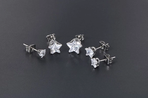 Three pairs of varied size star-shaped cubic zirconia stud earrings in silver settings