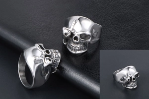 Detail of silver skull ring with gothic punk styling and polished finish on leather