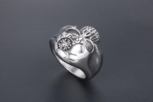 Macro detail of vintage skull stainless steel ring with antique silver relief finish