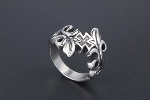 Macro detail of retro stainless steel ring featuring embossed cross and vine patterns