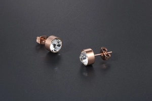 Macro shot of rose gold titanium steel stud earrings with brilliant round cut crystals