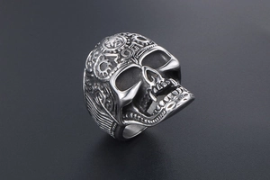 Macro detail of retro punk skull ring with star engraving and mechanical wing elements