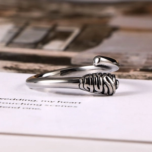 Minimalist vintage silver steel ring with textured detail on wooden background