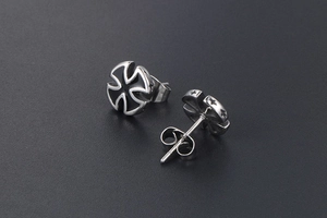 Close-up of titanium steel cross stud earrings with black enamel and push-back closure