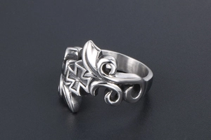 Macro detail of vintage titanium steel ring with carved vine patterns and cross symbol