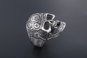 Macro detail of punk skull ring in silver steel with gear and pentagram engravings