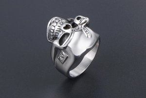 Close-up of polished stainless steel skull ring with intricate punk engraving details