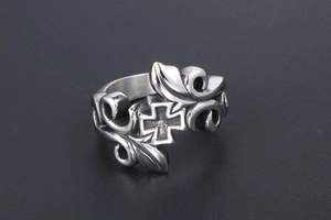 Macro shot of vintage titanium steel ring featuring gothic cross and vine relief detail