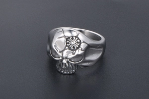 Detailed macro view of vintage skull ring with cracked texture and cross engraving detail