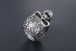 Macro detail of steampunk skull ring with mechanical gear relief in vintage titanium steel