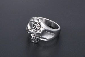 Detailed close-up of a Gothic skull ring with an engraved cross and vintage steel finish