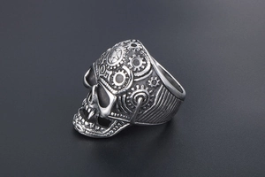 Detailed macro view of mechanical steampunk skull ring showing intricate gear engravings