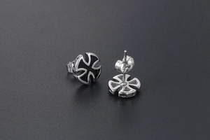 Detailed view of silver cross stud earrings with black enamel inlay and butterfly back