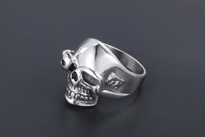 Macro shot of a punk style stainless steel skull ring with detailed mechanical eye detail