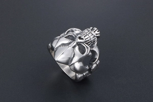 Detailed view of heavy vintage punk skull ring with textured grenade pattern finish