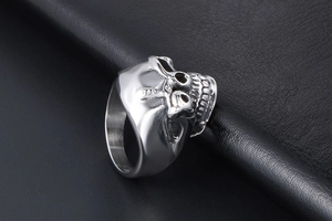 Macro shot of side view showing detailed punk skull engraving on heavy steel ring