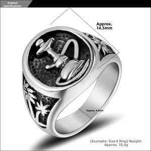 Detail view of vintage steel ring with engraved vessel and palm tree patterns