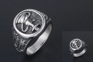 Macro shot of vintage titanium steel ring featuring trophy emblem and palm tree carvings