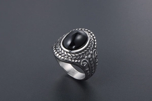 Macro detail of vintage silver steel ring featuring a large oval black gemstone inlay