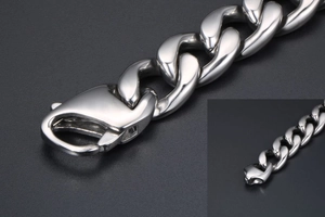 Detail of silver stainless steel cuban chain bracelet with heavy duty lobster clasp