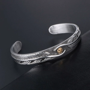 Retro stainless steel feather cuff bracelet with golden eagle emblem on black leather