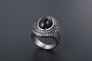 Detail of vintage steel ring with oval black onyx and embossed wheat pattern