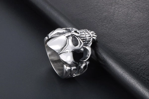 Close-up of vintage titanium steel skull ring with detailed Gothic bone carving