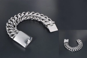 Detail of wide silver Cuban link chain with a polished rectangular clasp for men