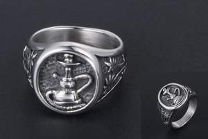 Detail of vintage carved signet ring with hookah pattern and industrial punk finish