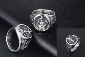 Detail of vintage steel ring featuring embossed hookah and palm tree patterns
