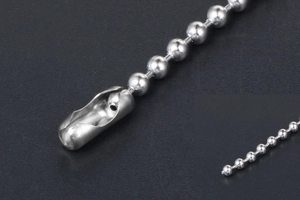 Detailed macro view of silver ball chain necklace featuring a secure connector clasp