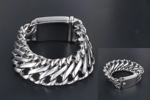 Macro shot of silver-tone stainless steel wide Cuban link bracelet with a secure clasp lock