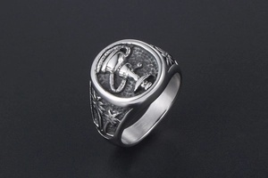 Macro detail of men's steel signet ring with engraved shisha and palm tree patterns