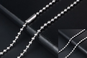 Detail of silver stainless steel bead chain with cylindrical clasp on black leather