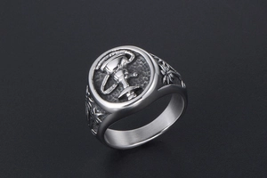 Detailed macro shot of vintage silver ring featuring a hookah emblem and palm trees