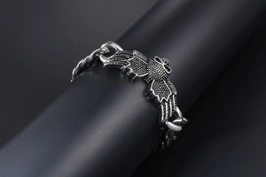 Close-up of punk style stainless steel bracelet with detailed eagle wing texture