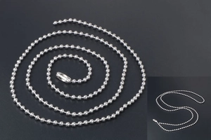 Close-up of a silver titanium steel ball chain necklace with polished round beads