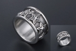 Macro shot of titanium steel ring with embossed five-pointed star pattern design