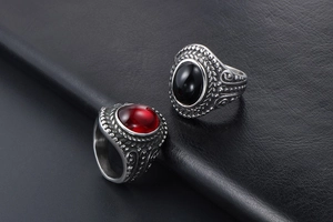 Detailed view of vintage titanium steel rings with red and black oval gemstones