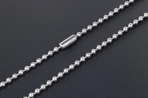 Macro shot of silver stainless steel ball bead chain with secure cylindrical clasp