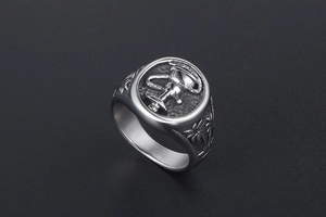 Detailed view of vintage signet ring featuring embossed hookah and palm tree motifs