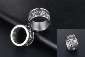 Detail of vintage silver titanium steel ear plugs with embossed five-pointed star pattern