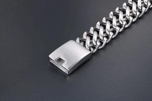 Detailed macro view of wide stainless steel weave chain bracelet with rectangular box clasp