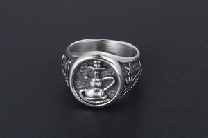 Detailed macro view of vintage titanium steel ring featuring a hookah relief and leaf pattern