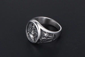 Macro shot of silver titanium steel signet ring with engraved hookah and palm tree patterns