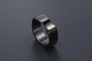 Detail of square black stainless steel ring with polished finish and brushed inner band