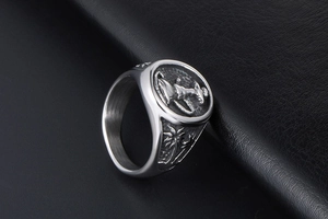 Macro detail of vintage silver steel ring featuring figure relief and palm tree texture