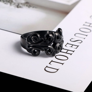 Macro view of gothic black titanium steel ring with intricate floral relief carving