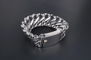 Macro shot of heavy stainless steel Cuban link bracelet with secure clasp and polished finish