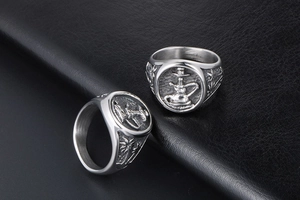 Macro view of vintage titanium steel rings featuring embossed hookah and palm patterns